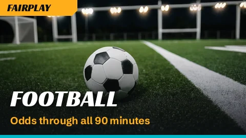 Football resting on a floodlit penalty spot at night